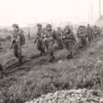 Canadian Infantrymen marching across Normandy