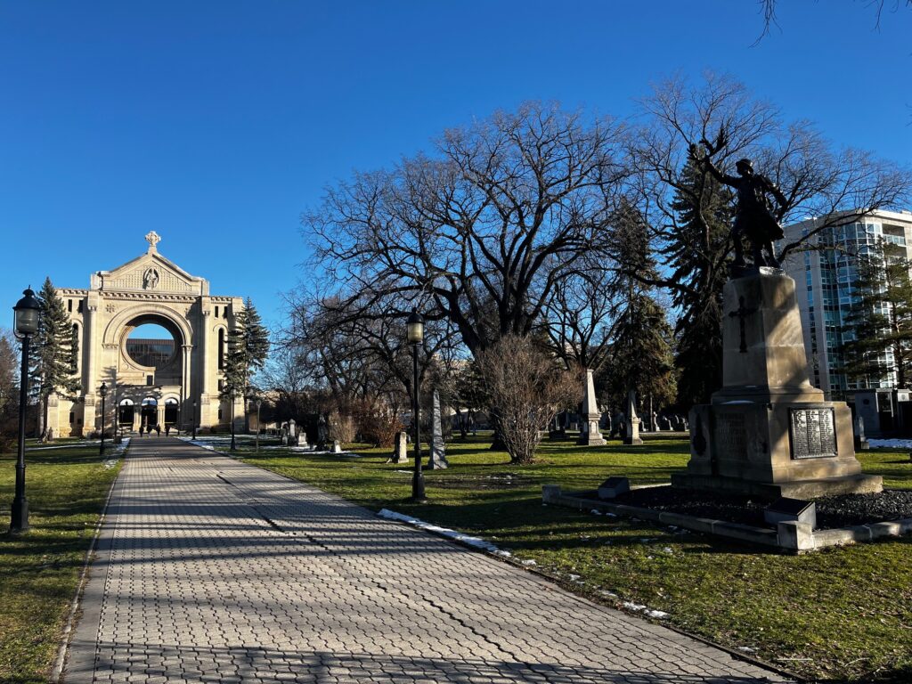 The monument is located near the Taché Avenue gate of the St. Boniface Cathedral grounds.